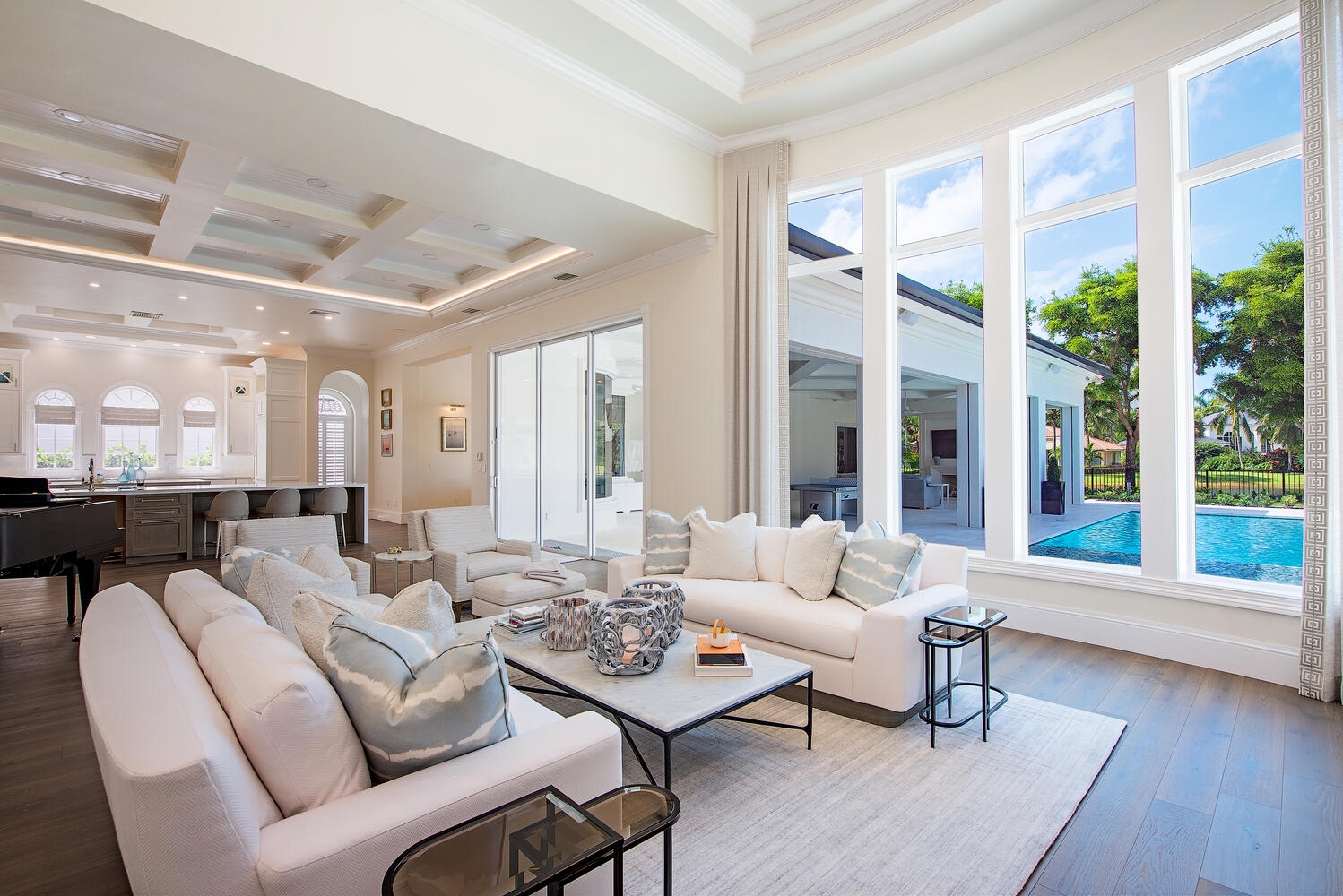 Living room with coffered ceiling, paneled walls and tall French doors